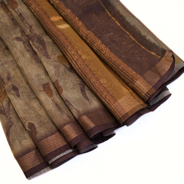 Tissue organza saree with zari border and all over prints.