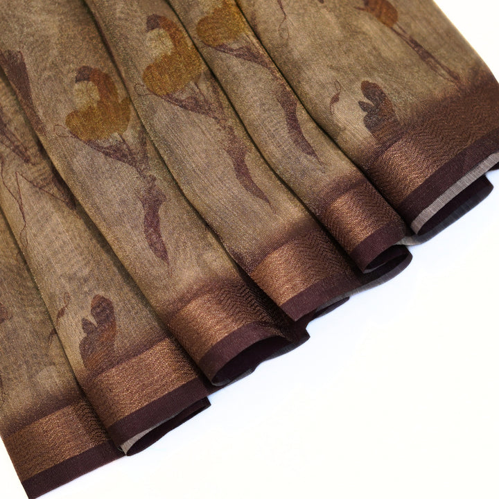 Tissue organza saree with zari border and all over prints.