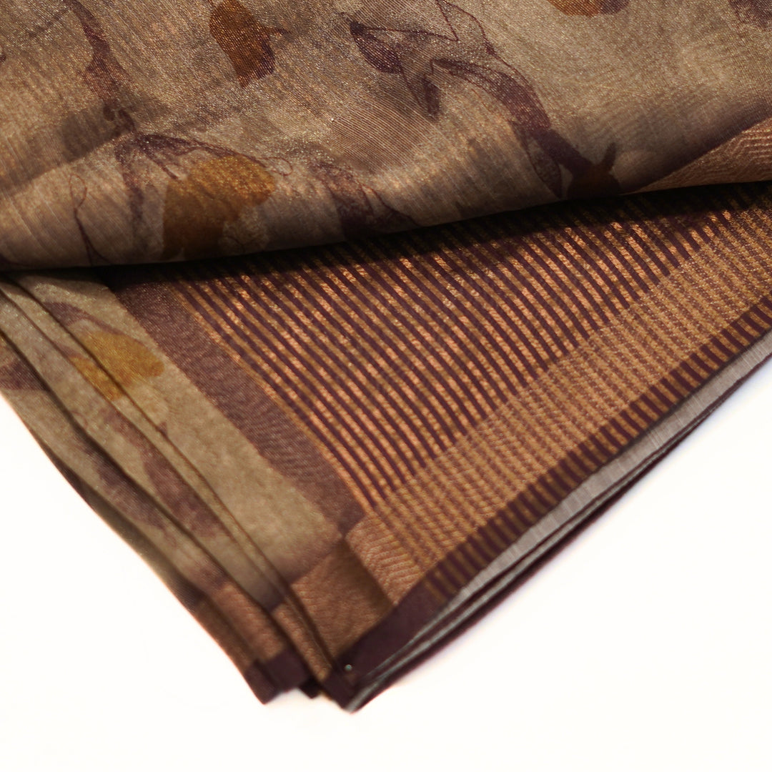 Tissue organza saree with zari border and all over prints.