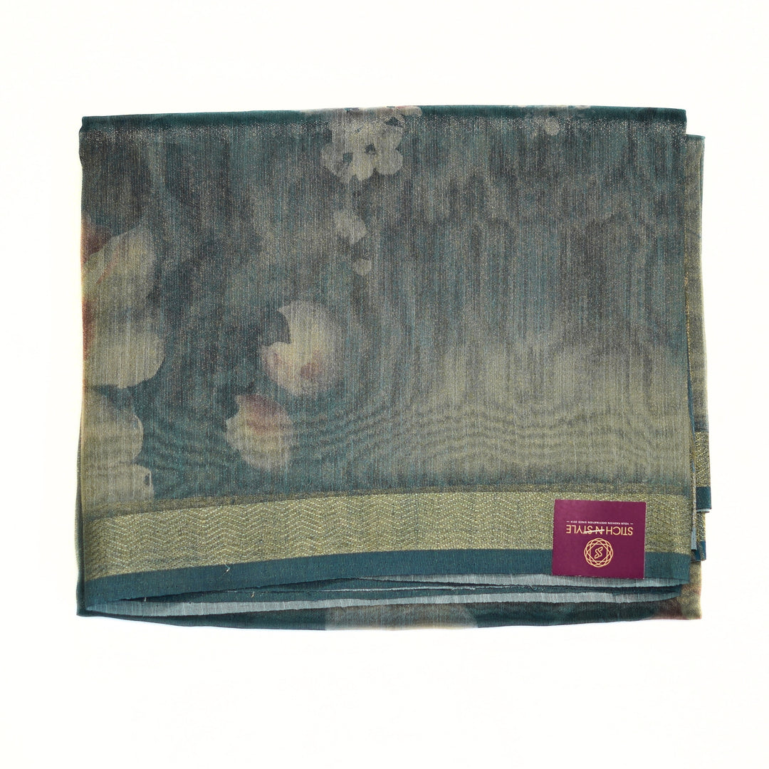 Tissue organza saree with zari border and all over prints.