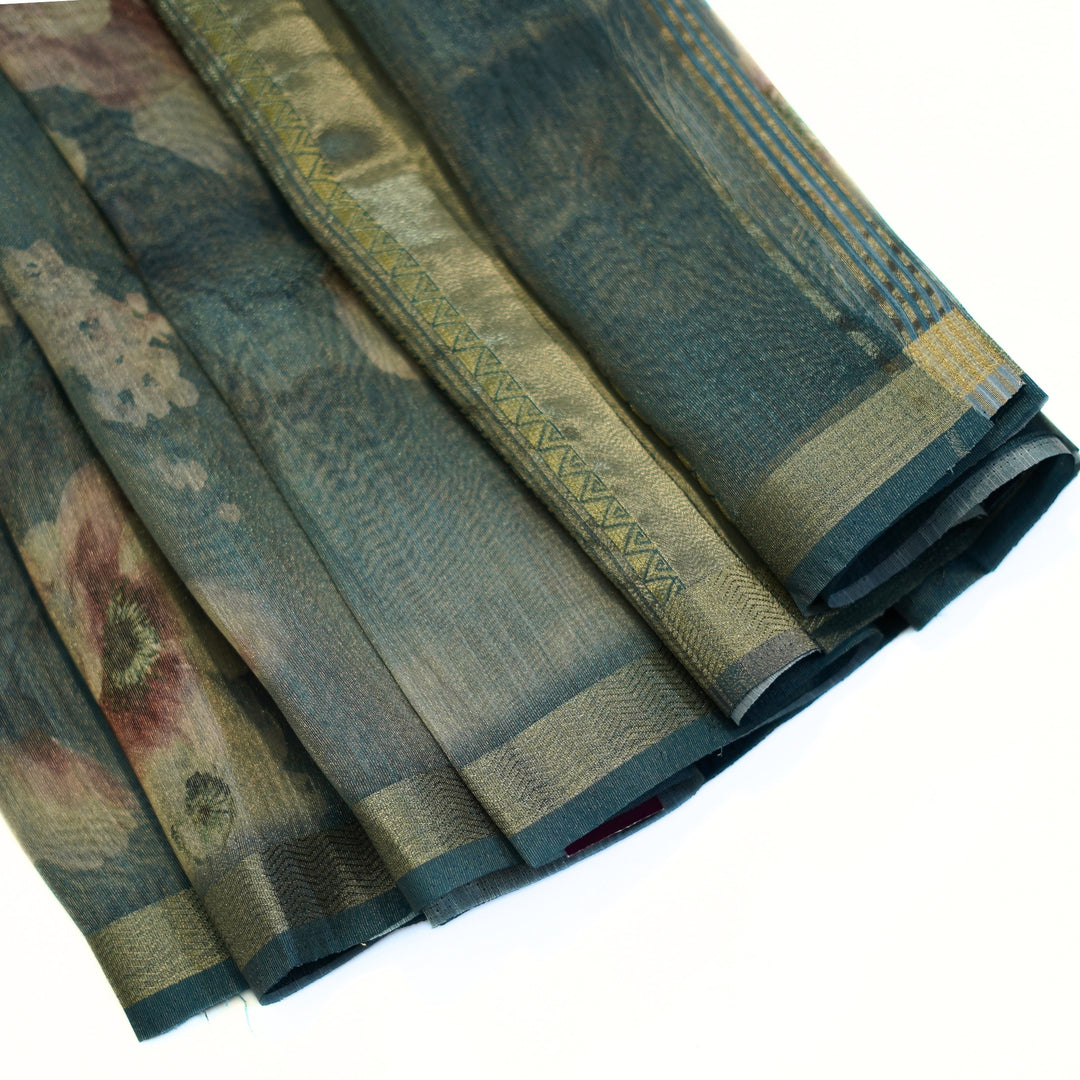 Tissue organza saree with zari border and all over prints.