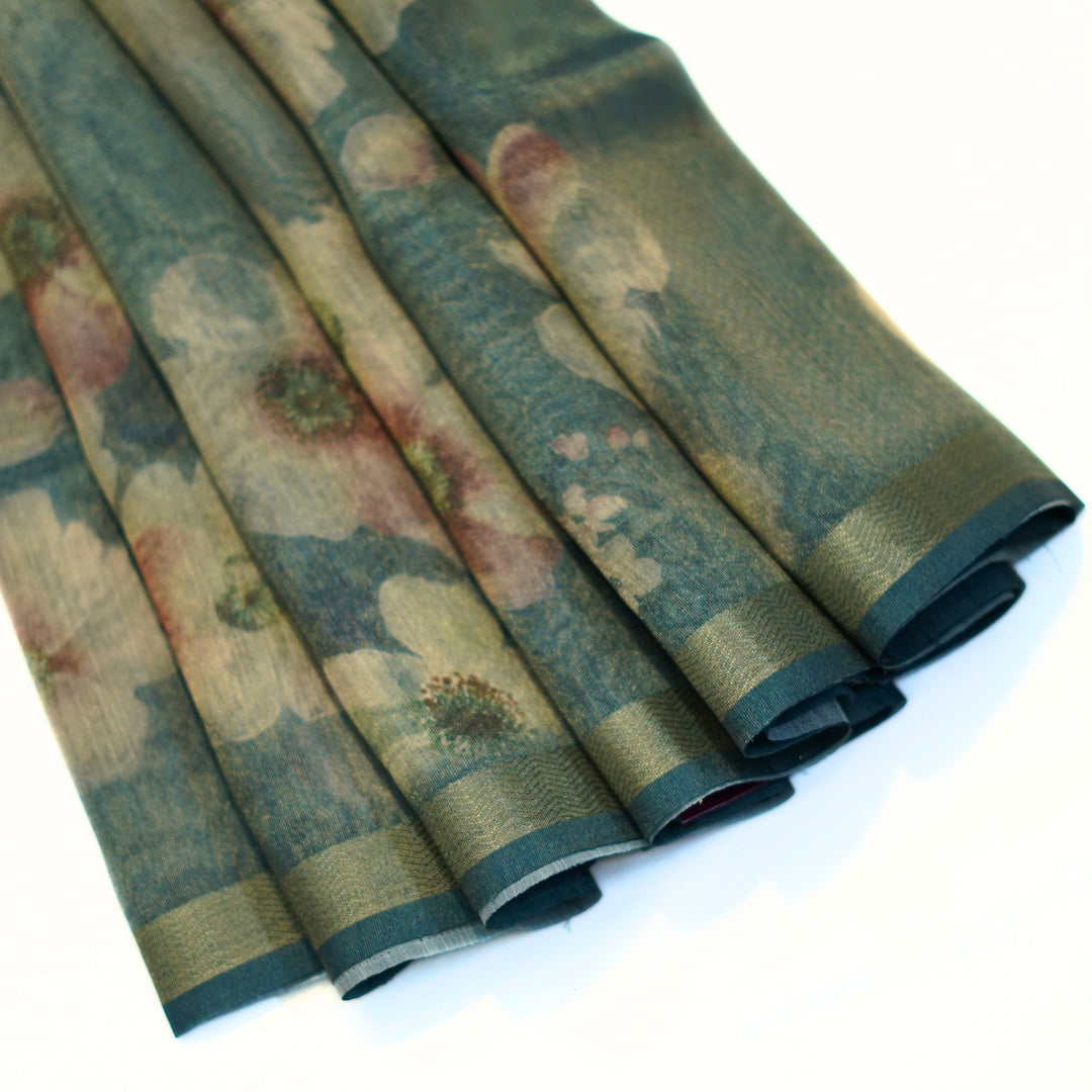 Tissue organza saree with zari border and all over prints.