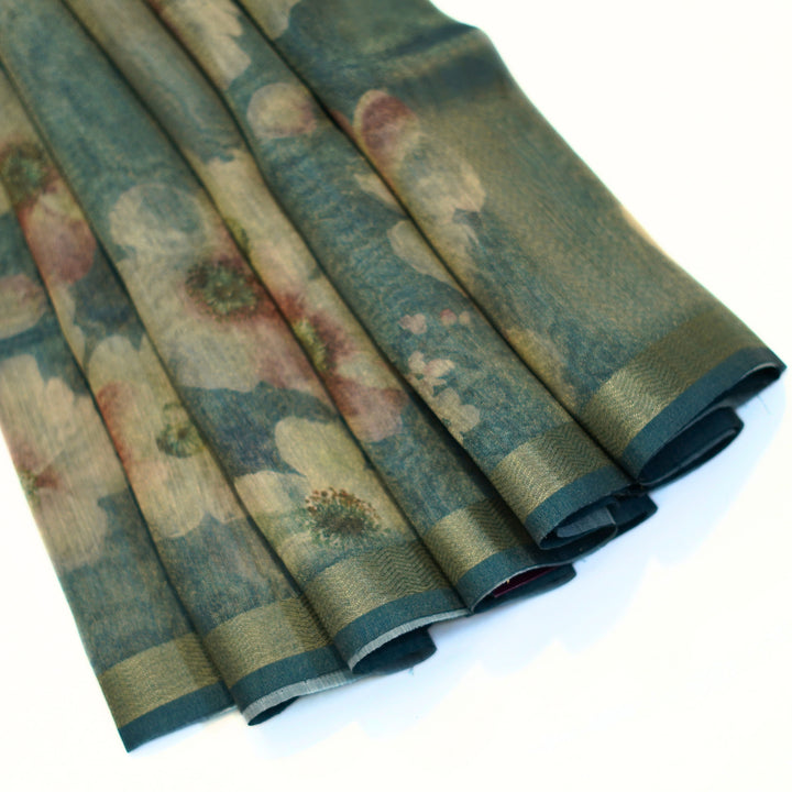 Tissue organza saree with zari border and all over prints.